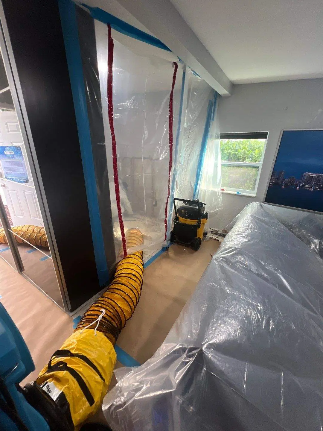 Mold restoration equipment installed inside a residential kitchen and living area after water damage